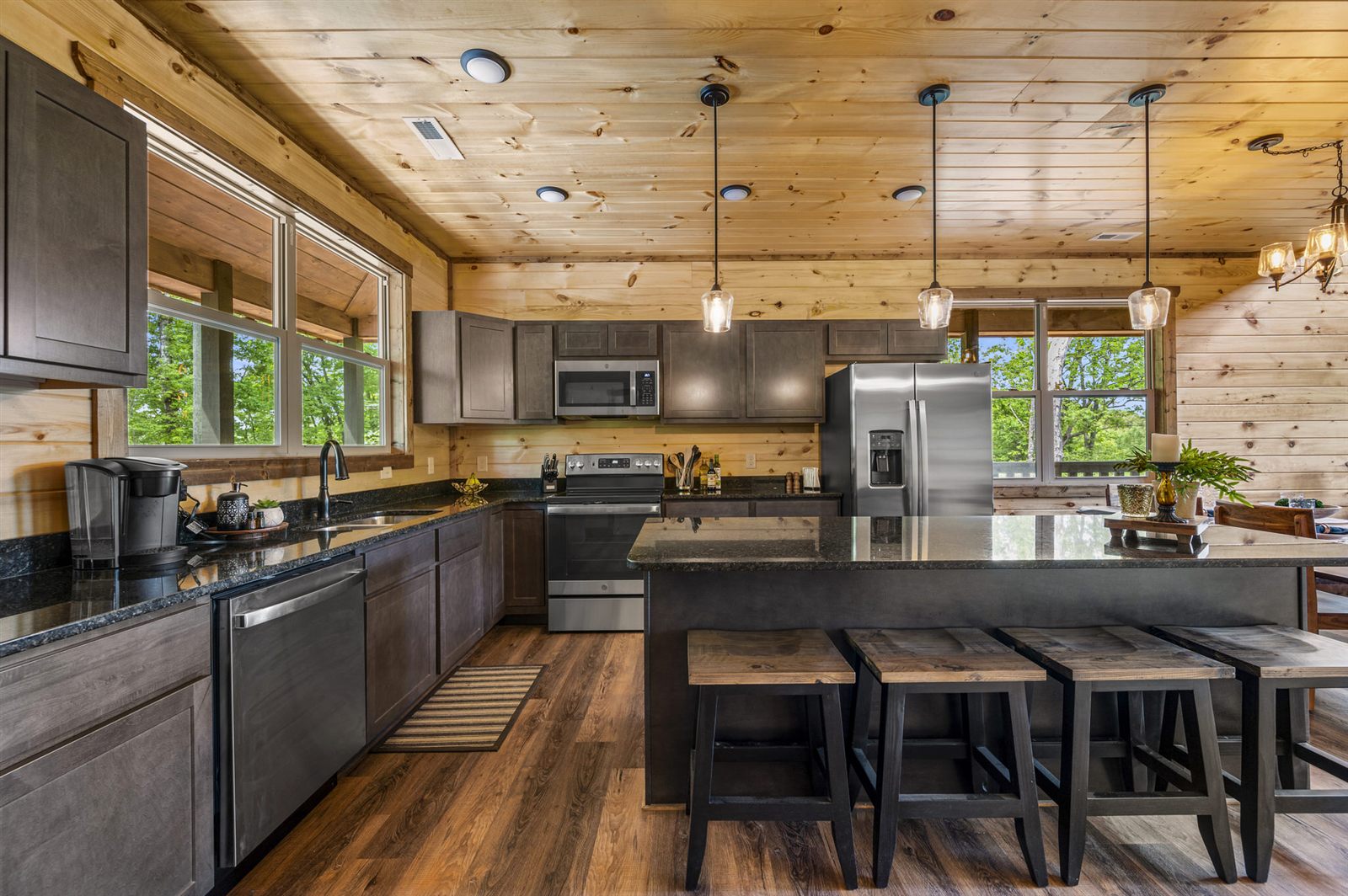 Cabin kitchen with wood ceiling and stainless appliances