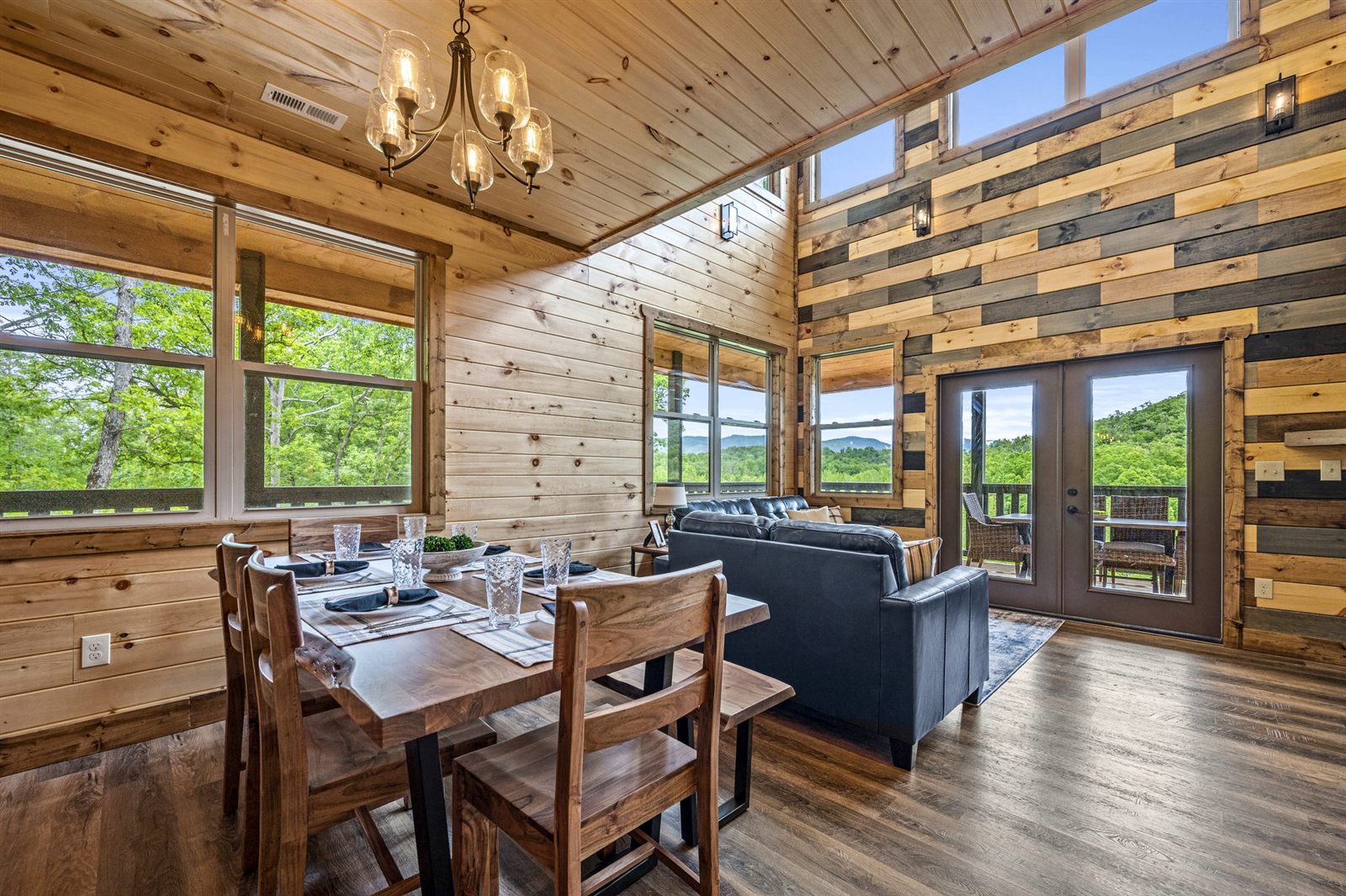 Vaulted great room with dining table and living area